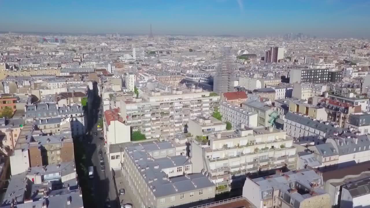 Densely populated urban neighbourhoods and buildings of Paris, France, aerial flyover.