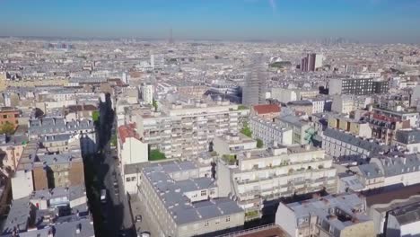 densely populated urban neighbourhoods and buildings of paris, france, aerial flyover.