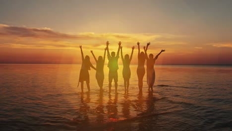 a group of five young teenager friends travel to the beach looking at the sea