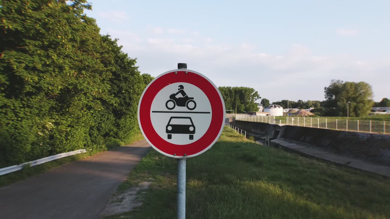 Drone flies away from roadsign on a german road cars and motorcycles prohibited on a bright sunny day