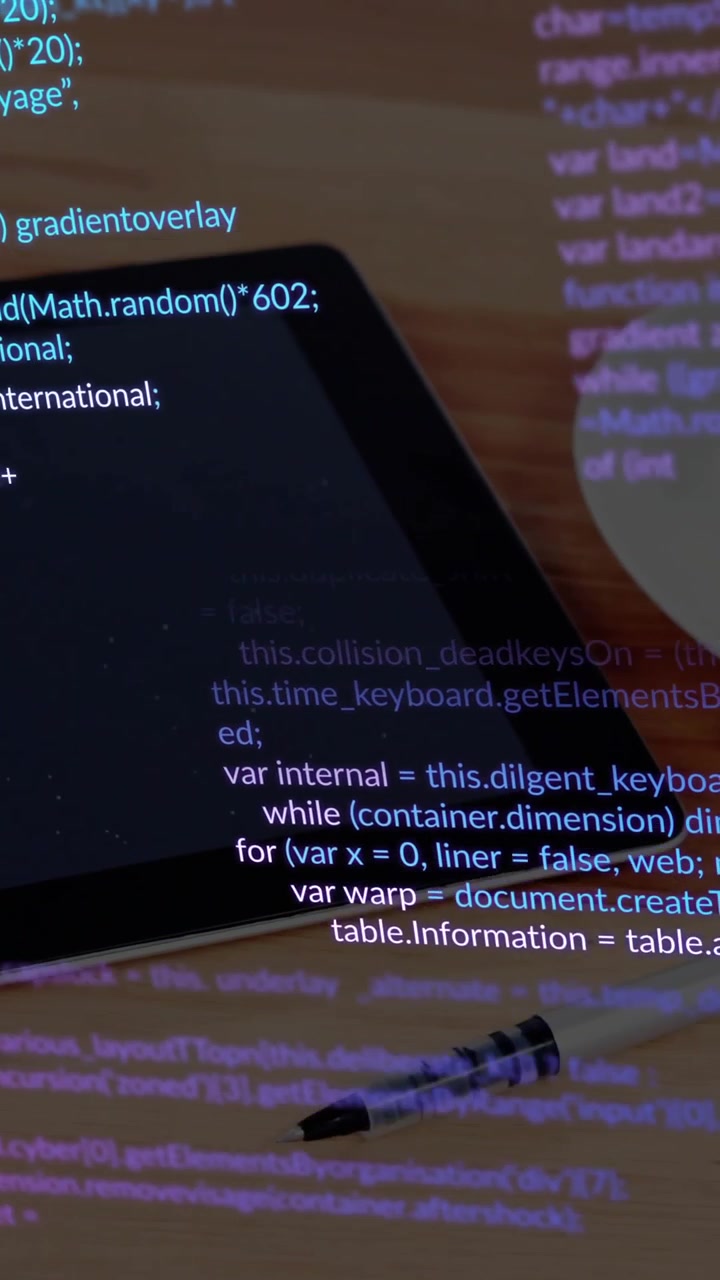 Tablet with programming code and pen on wooden desk, animation showing