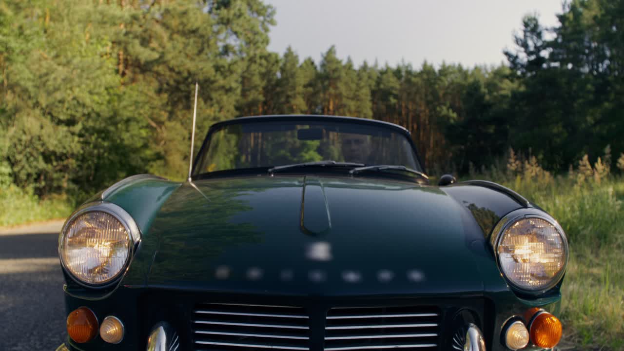 Vintage Convertible Car on a Forest Road