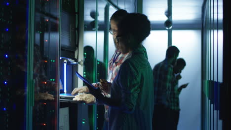 it professionals working in a server room