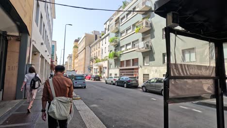 two people walking down a milan street