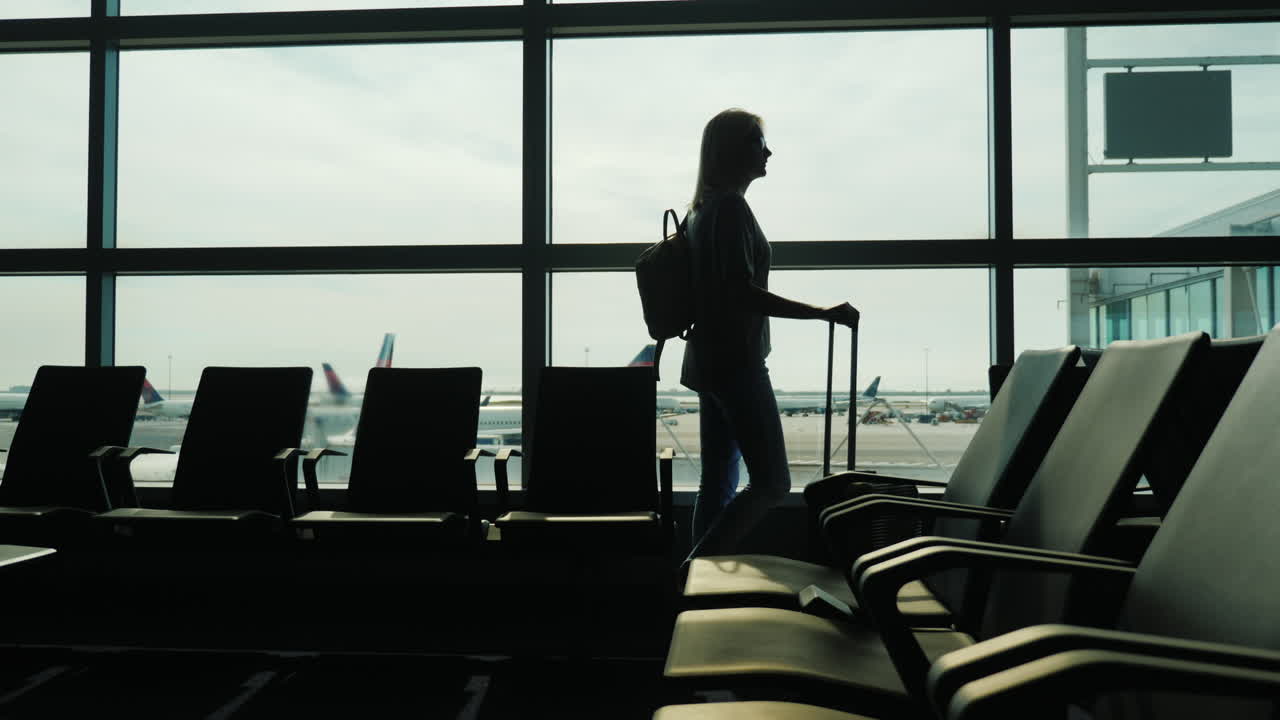 Woman Watches Planes in Airport