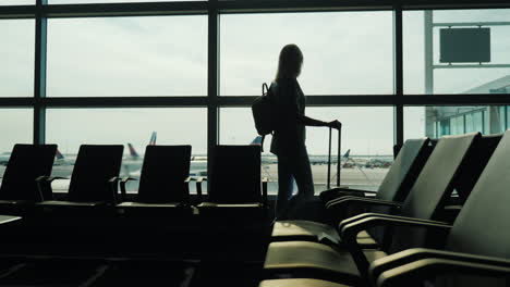 woman watches planes in airport