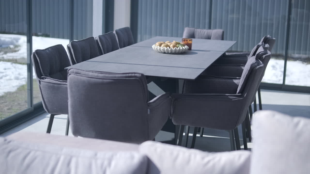 Modern Dining Table and Chairs in a Bright Room with Winter View