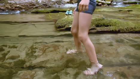 child walking in a shallow creek