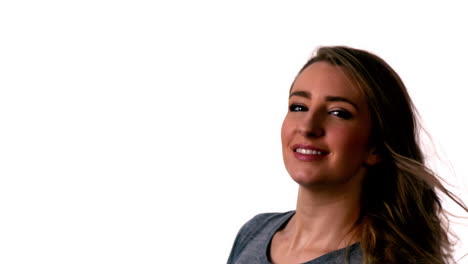 Pretty-blonde-smiling-at-the-camera-and-tossing-hair