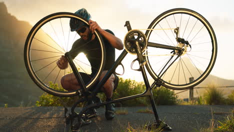 bicycle, wheel and tyre on road with man athlete