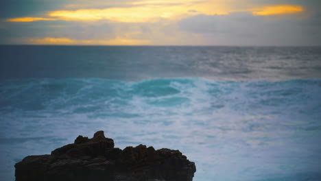 ocean hitting coastline rock in early morning closeup. beautiful evening seaside