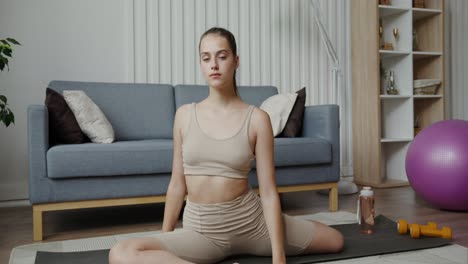 young woman doing yoga at home