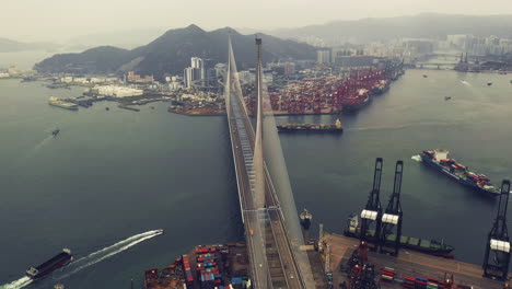 aerial view of a cable-stayed bridge over a busy port in hong kong