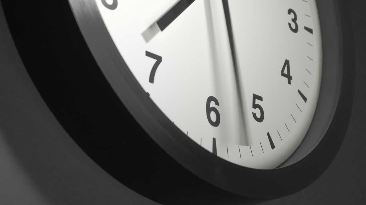 Clock Face in Time Lapse on Dark Grey Wall