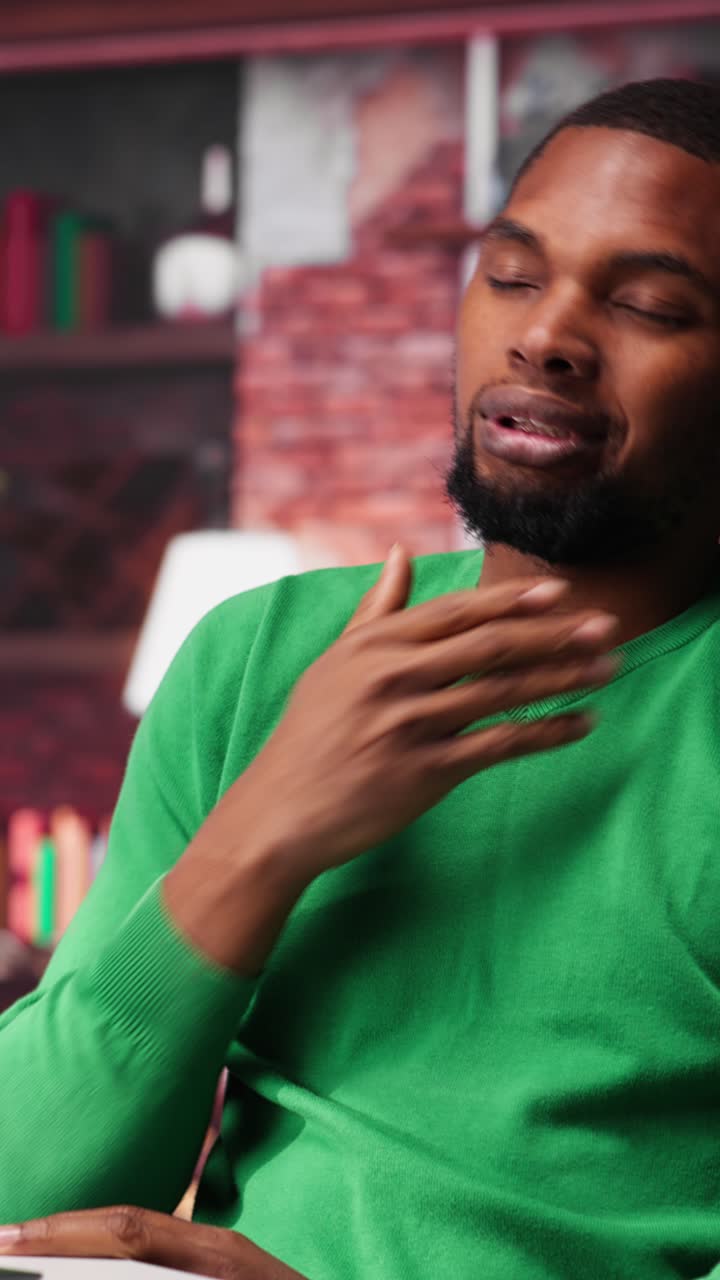 Vertical Video African american teleworker experiences lower back pain due to incorrect posture