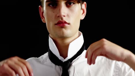 androgynous man adjusting his tie