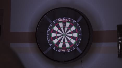 A-dartboard-with-precise-hits-on-the-triple-20-in-a-dimly-lit-room