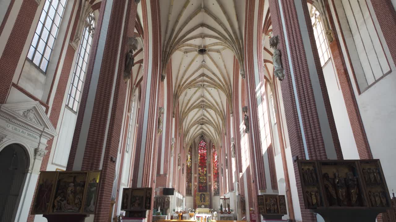 Inside the Church of Our Lady on the Sand in Wroclaw, Poland. High vaulted ceilings, stained glass windows. Tilt Down View From Ceiling