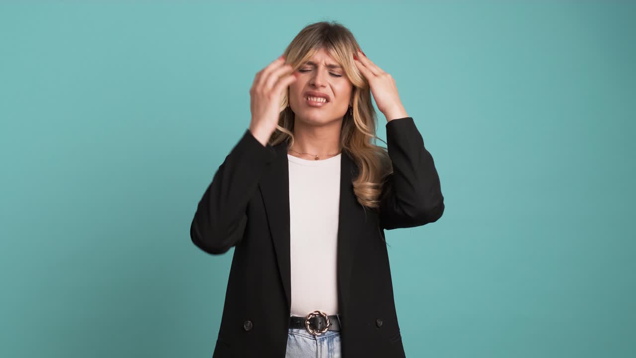 Tired transgender businesswoman suffering from headache