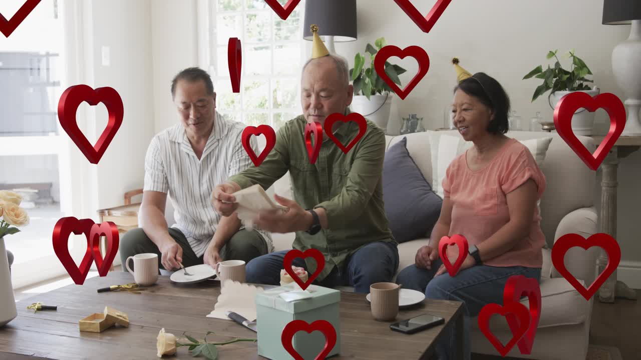 Center man reaching for blue box, opening gift, serving cake, AR hearts drifting birthday ad