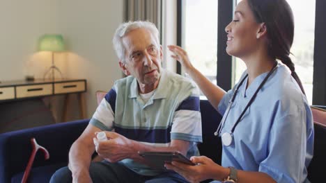 Animation-of-happy-biracial-female-doctor-talking-about-medicines-with-caucasian-senior-man