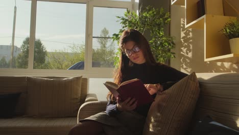 woman reading a book in a cozy cafe