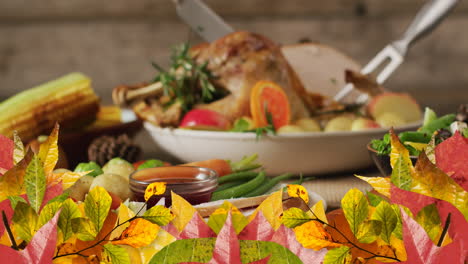 Animation-of-autumn-leaves-over-thanksgiving-dinner-background