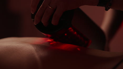 woman receiving red light therapy massage at a spa