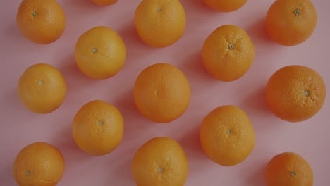 oranges on a pink background