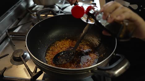 Soy-Sauce-Being-Added-To-Simmering-Garlic,-Chilly-Past-Inside-Saucepan