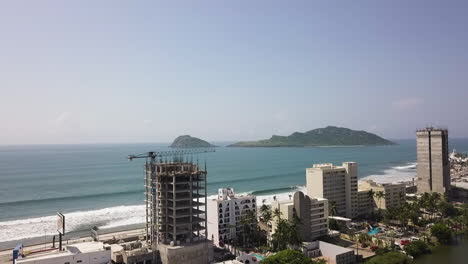 Tower-crane-attached-to-a-building-under-construction-next-to-the-beach