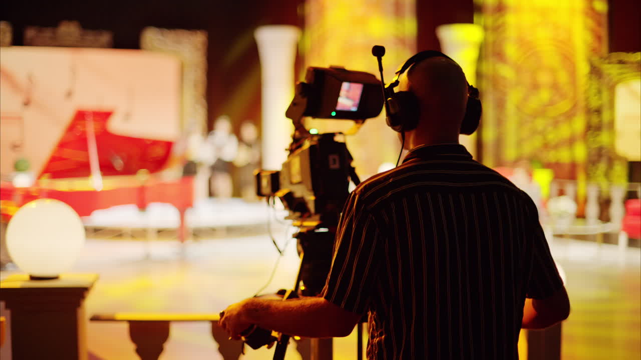 Man filming with professional camera on the backstage of a TV set