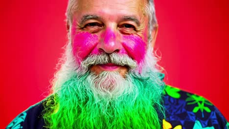 smiling senior man with colorful face paint and beard