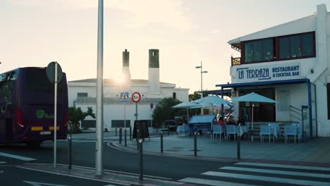 sunset city street scene with restaurant and people