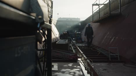 man in protective workwear building ship at the shipyard. wide