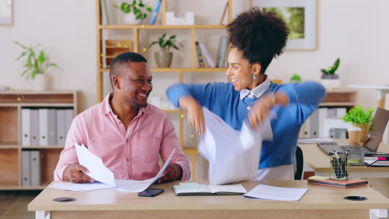Happy people throw papers in office success