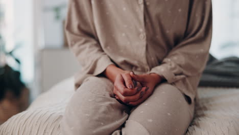 woman in pajamas sitting on bed