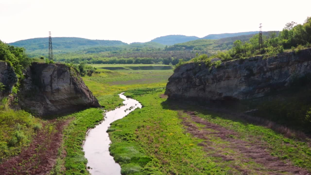 A river between rocky formations on a sunny day
