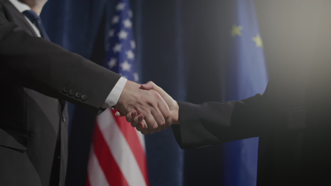 Handshake between Politicians in front of American and European Union Flags