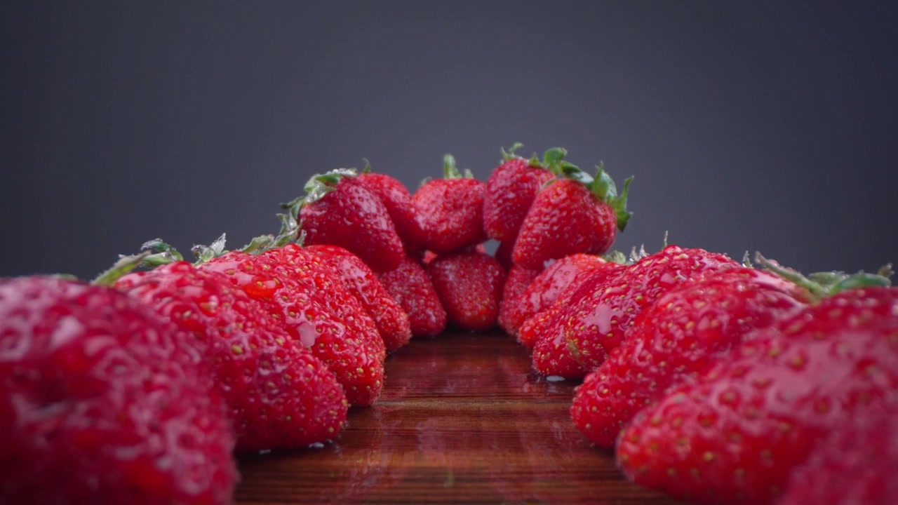 Vibrant Red Strawberries with Water Droplets on Dark Background