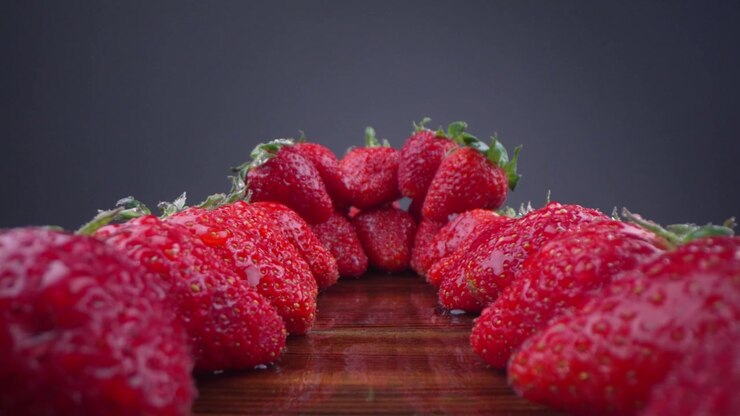 Vibrant Red Strawberries with Water Droplets on Dark Background