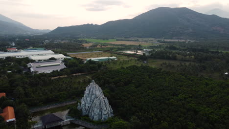 aerial circling palm tree forest, sand formation tourism object, ninh thuan, vietnam