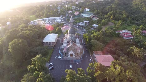 aerial drone shot over sacre coeur in martinique at sunset