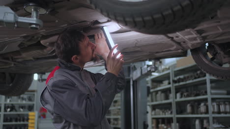 The-mechanic-inspects-the-day-of-the-car-on-the-lift