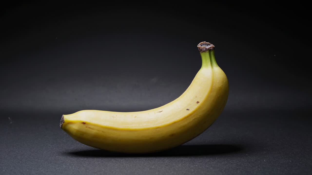 Aging banana in dramatic lighting, captured from a low angle