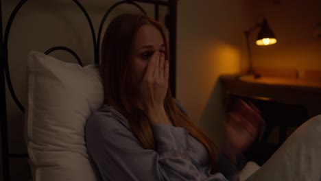 woman crying in bed