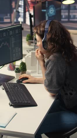 vertical video financial investor works on pc analyzing stock market trends