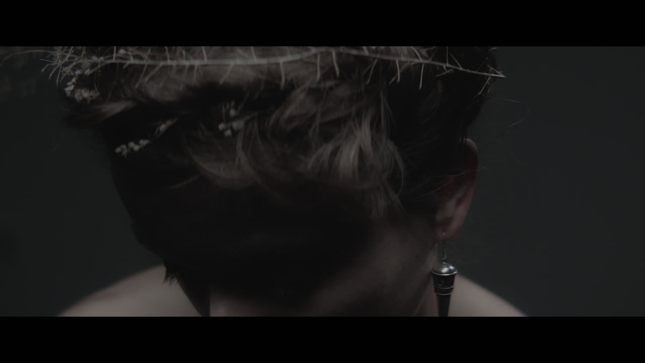 A woman dressed as mother nature shows her hair