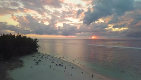 a slow timelapse sunset beach with people walking 4k