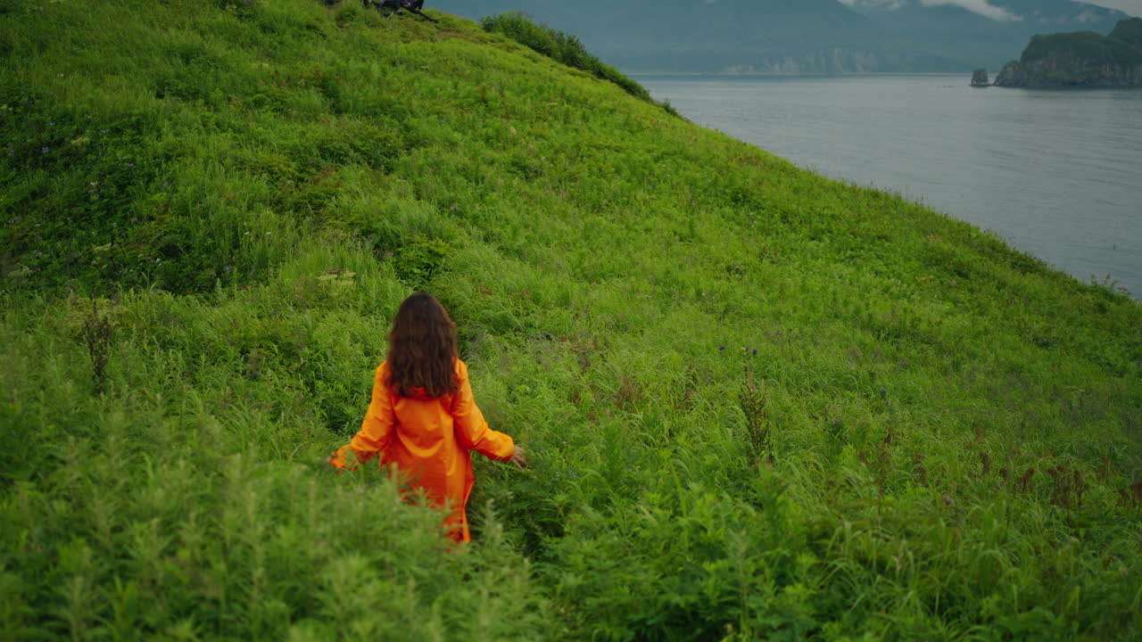 Woman Hiking on a Coastal Hill
